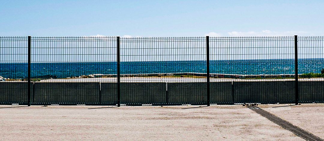 fence in front of the ocean