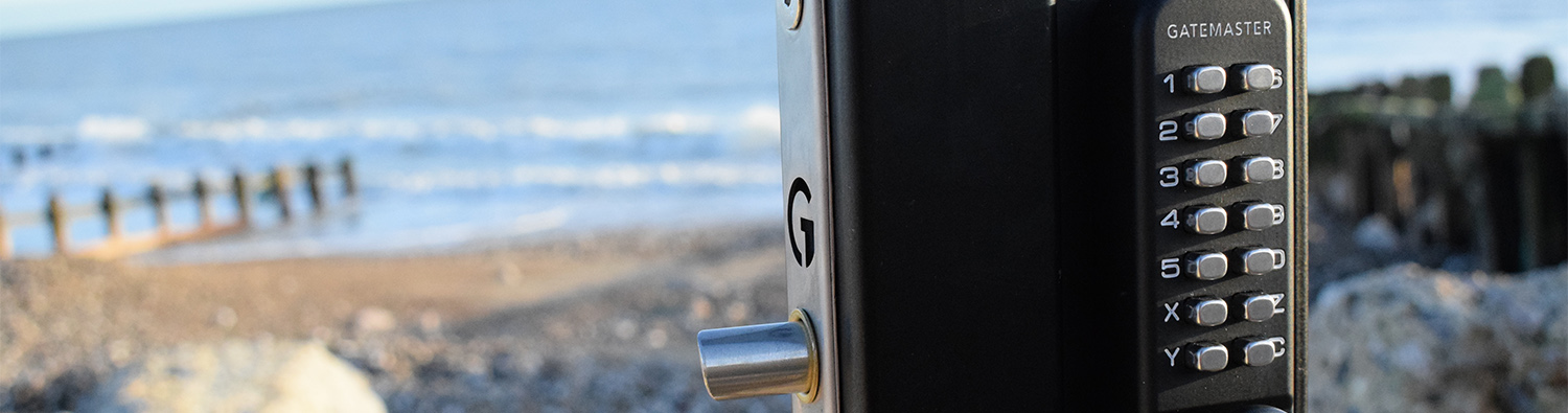 close-up of mechanical code lock in front of beach and sea