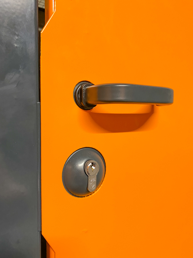 Close up image of grey bespoke lock in yellow steel door