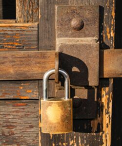 padlock on locking latch. Installed on old wooden gate/door