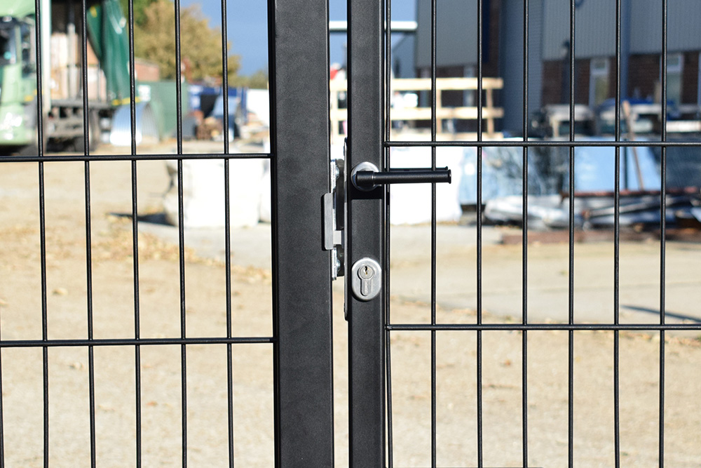 mortice lock installed in gate frame in front of industrial unit. 