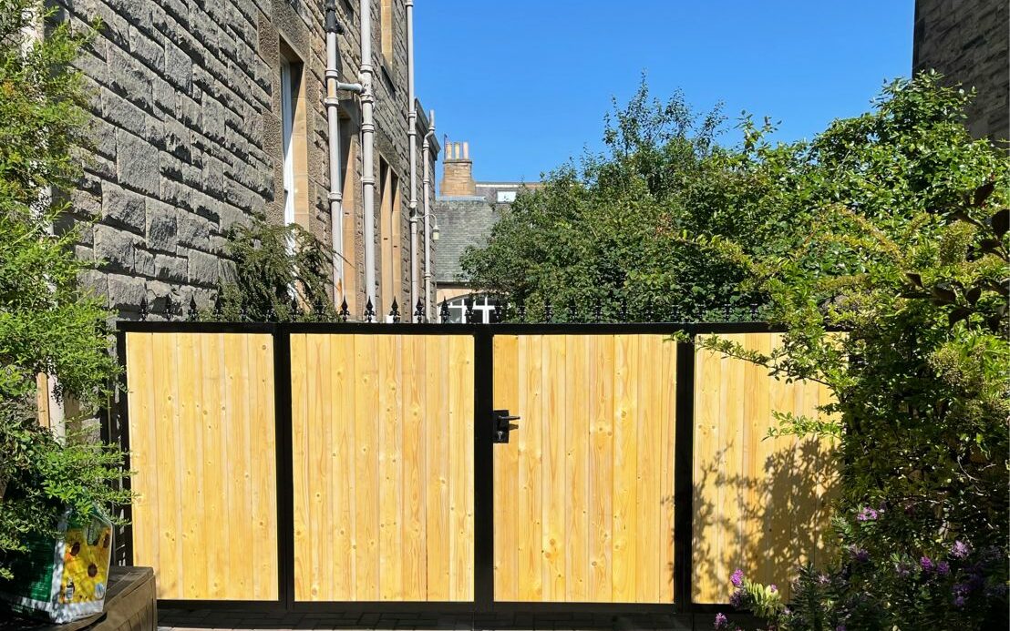 composite gate with metal frame and installed bolt on lock.