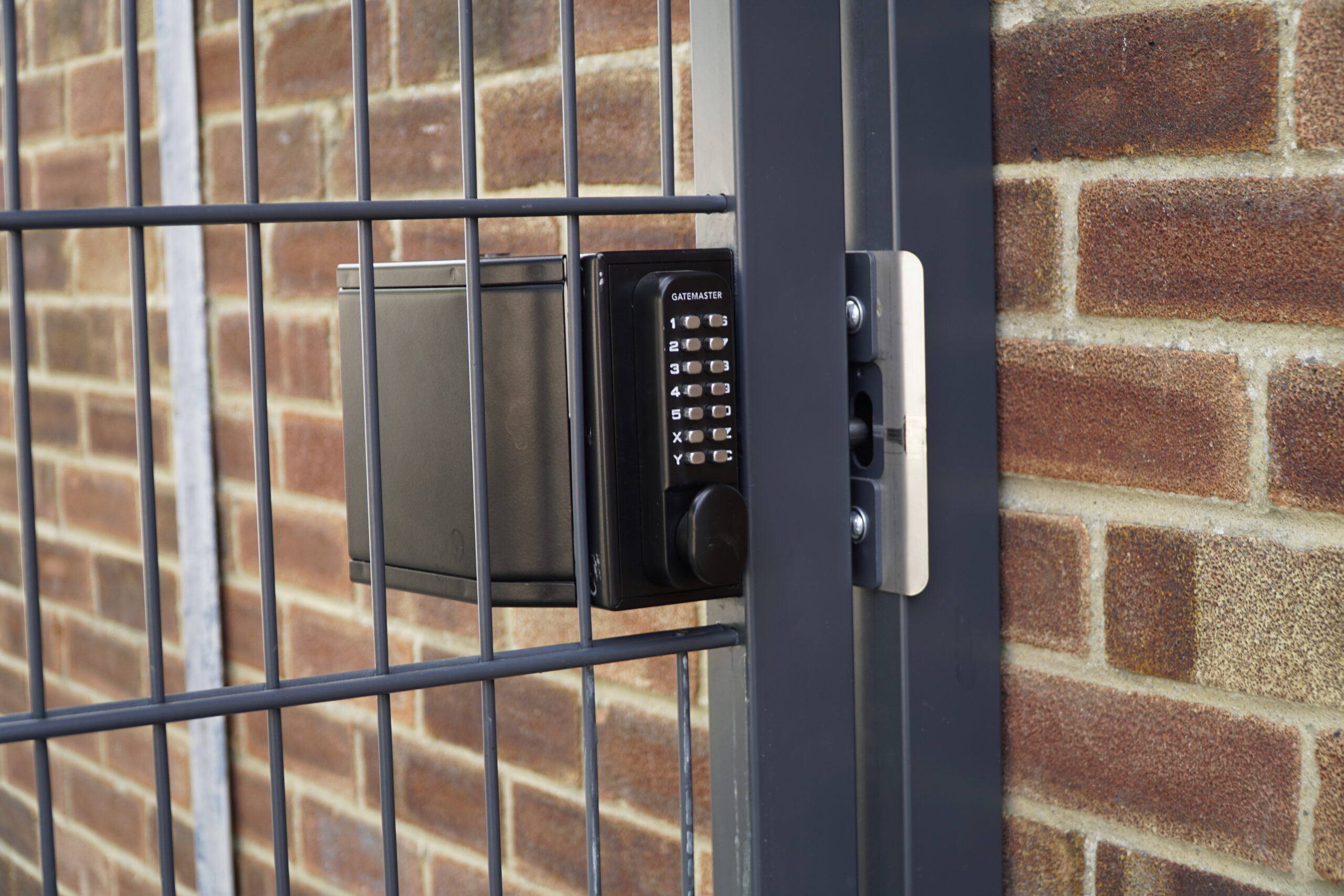 protective gate shroud on a locked gate in front of a brick wall