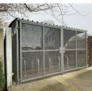 Weld in locking solution for bike storage units. Grey metal bike unit with two locks on each door.