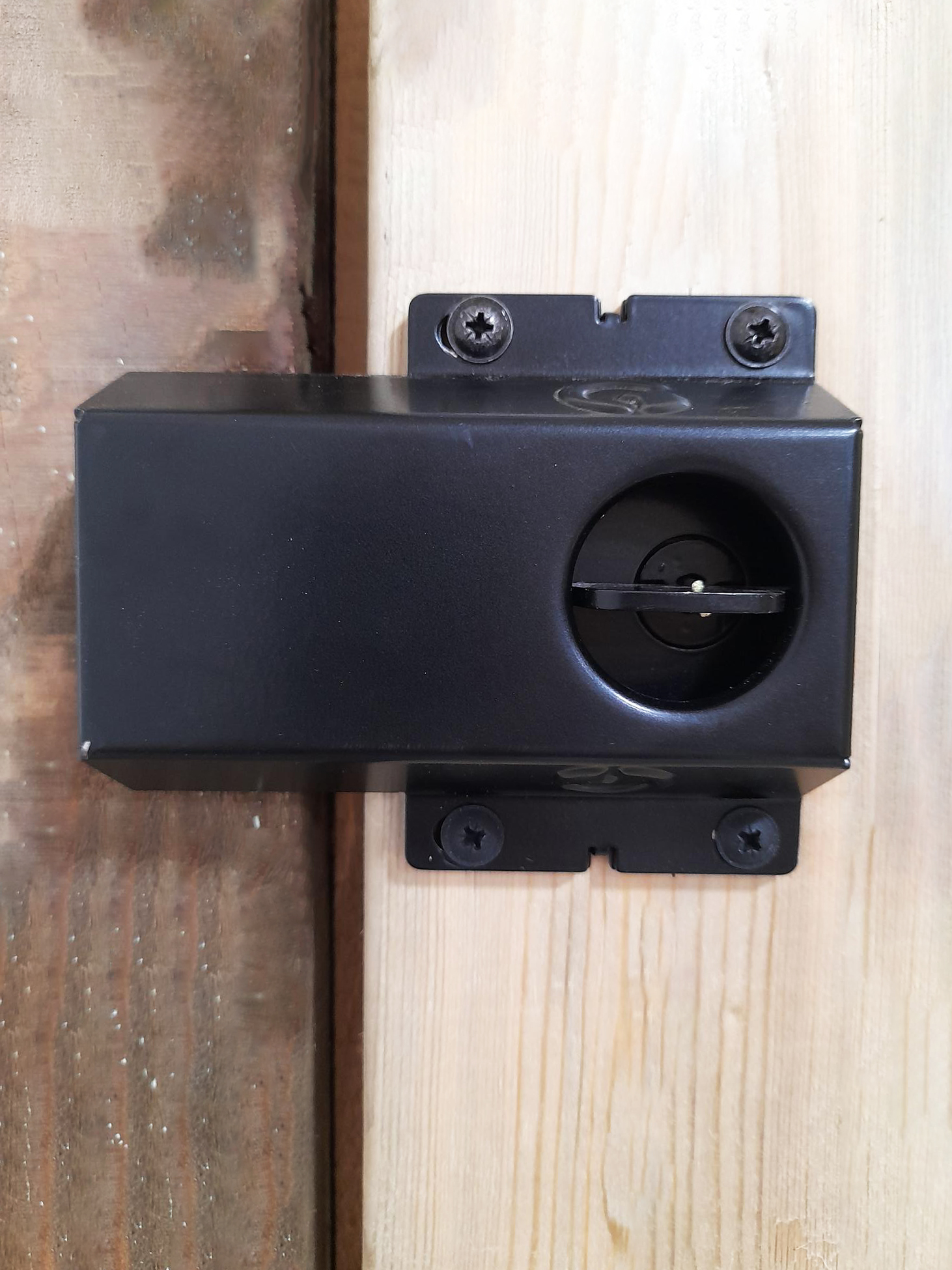 back of black surface mounted gate lock