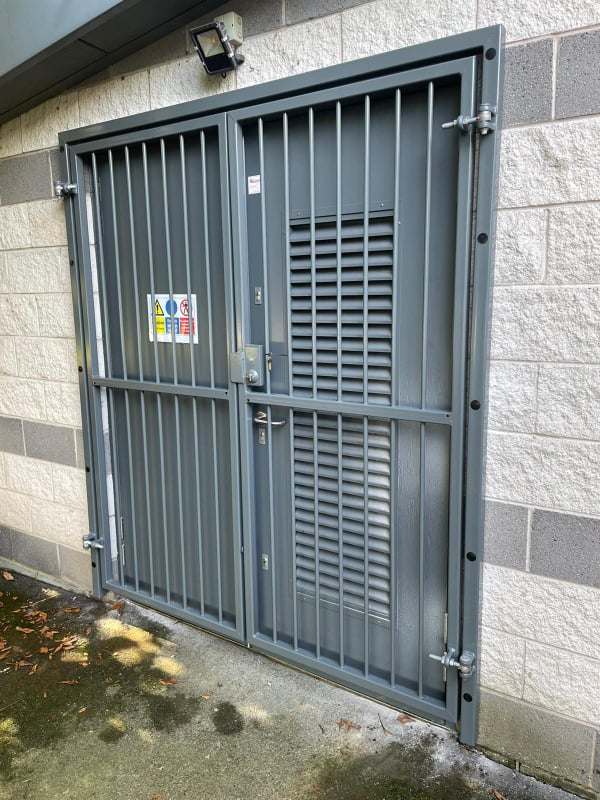 Grey mesh gate to stop access to a leisure centre with deadlock and heavy duty hinges installed