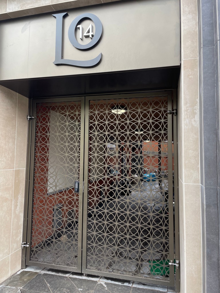 Ornate metal gate installed on a restaurant staff entrance.