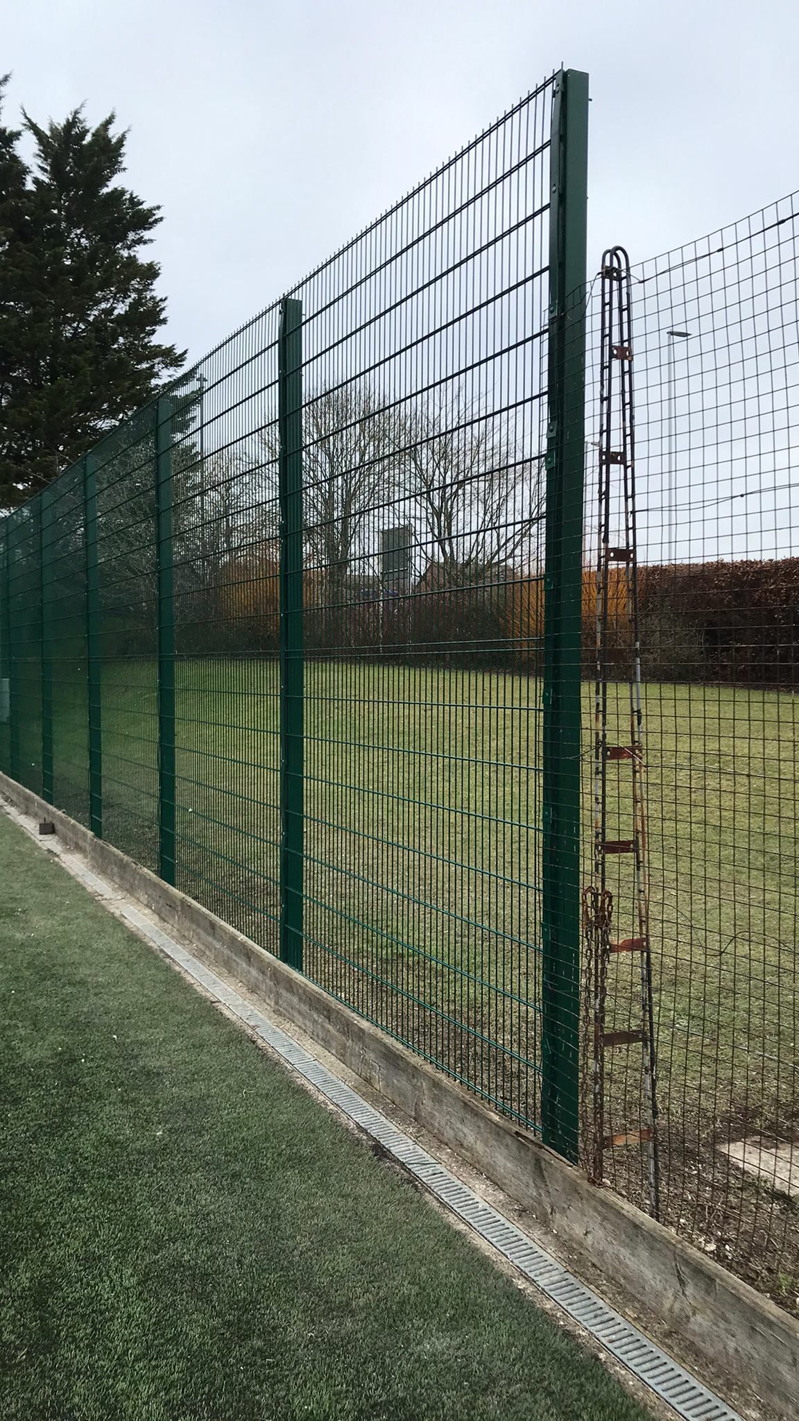 twin mesh fencing in front of sport facilities at school.